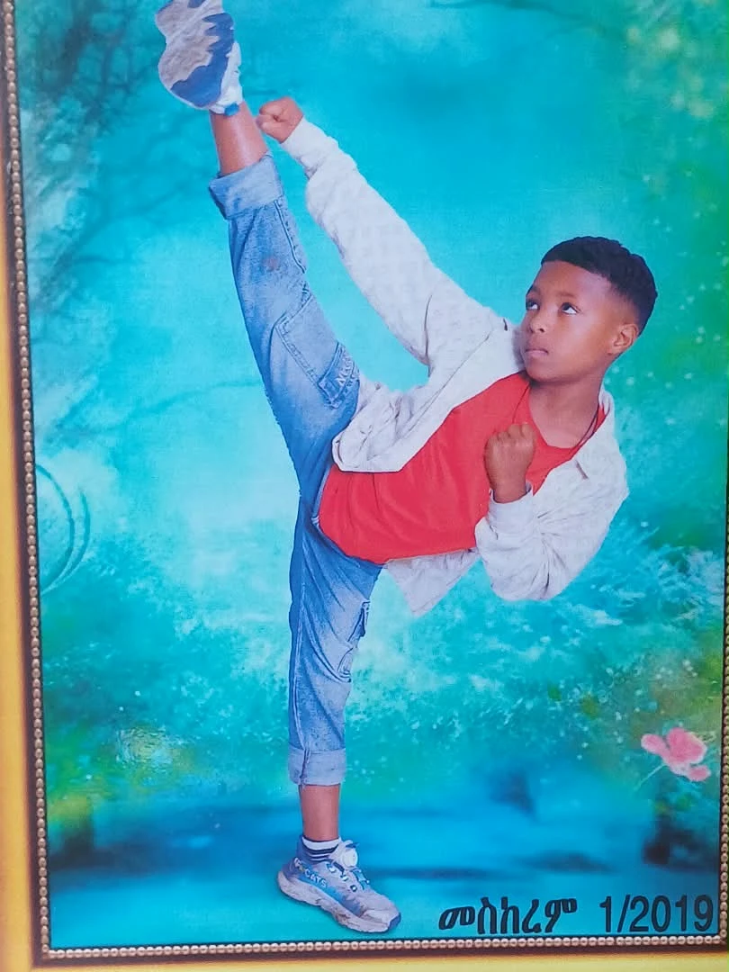 Young athlete demonstrating a high kick in a framed portrait